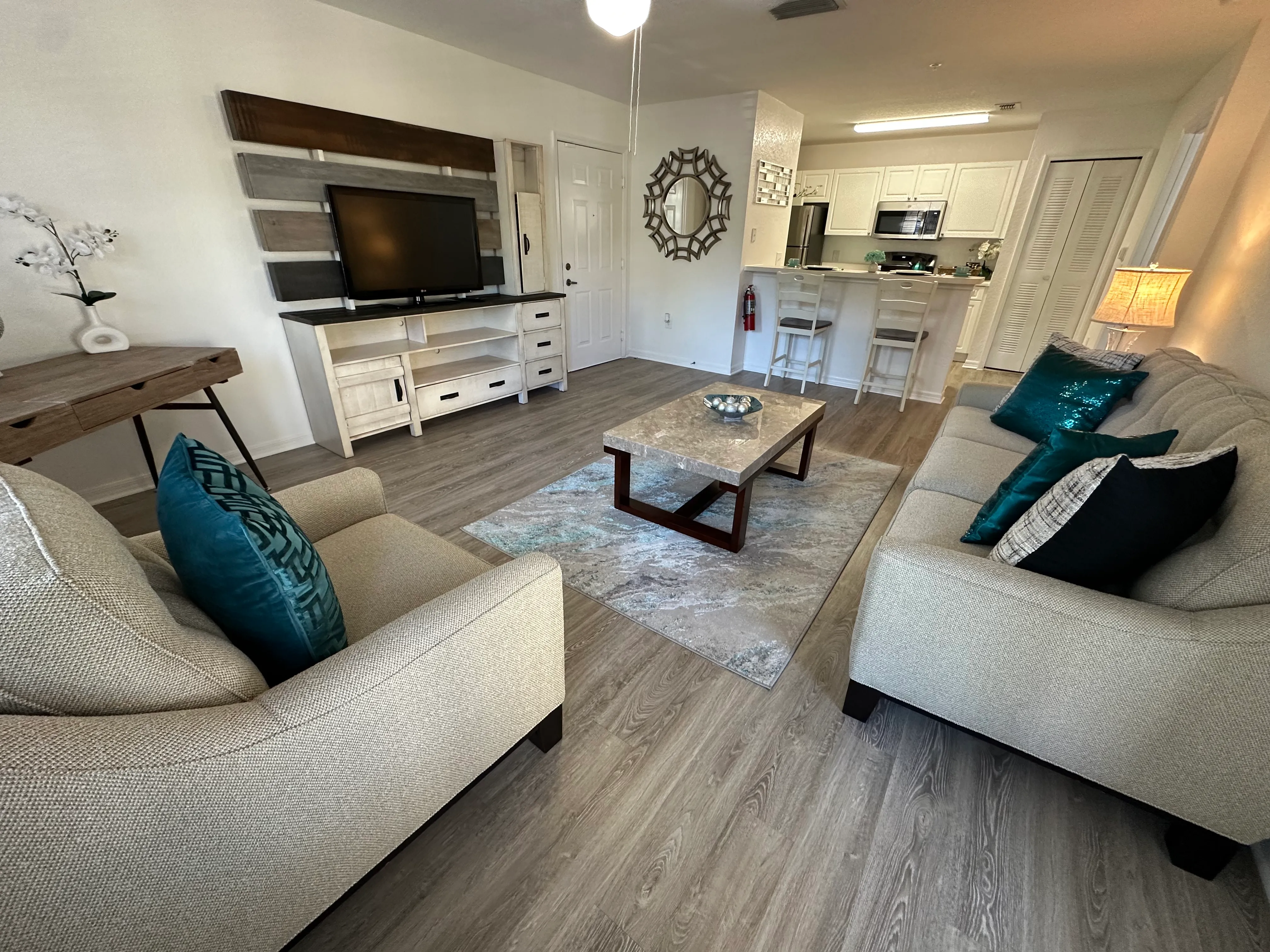 A living room with a couch, a coffee table, and a television.
