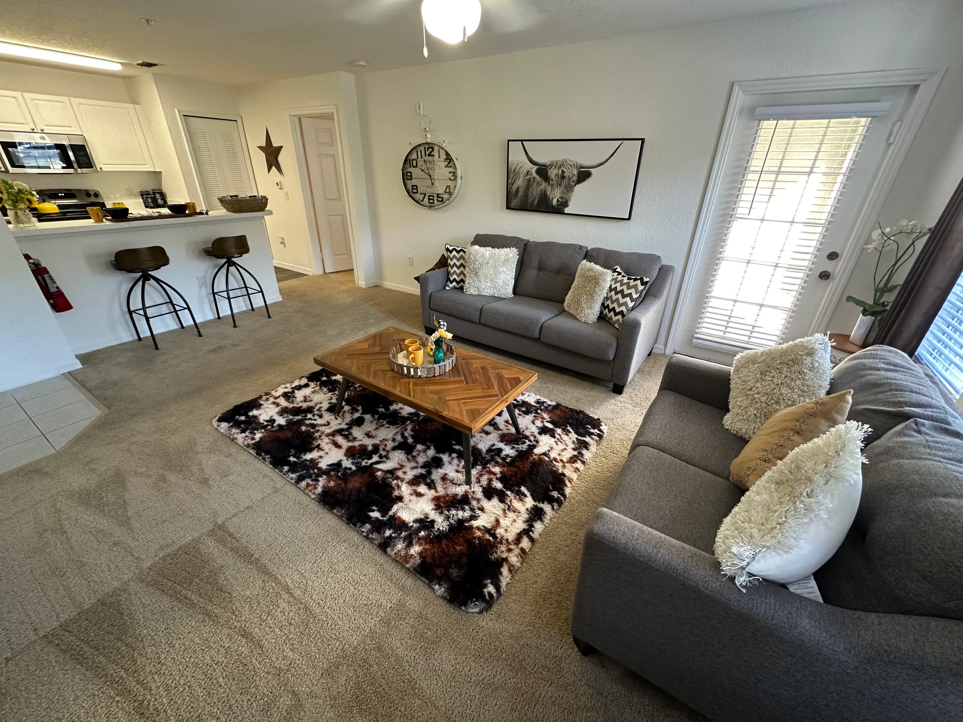A living room with a grey couch and a coffee table.