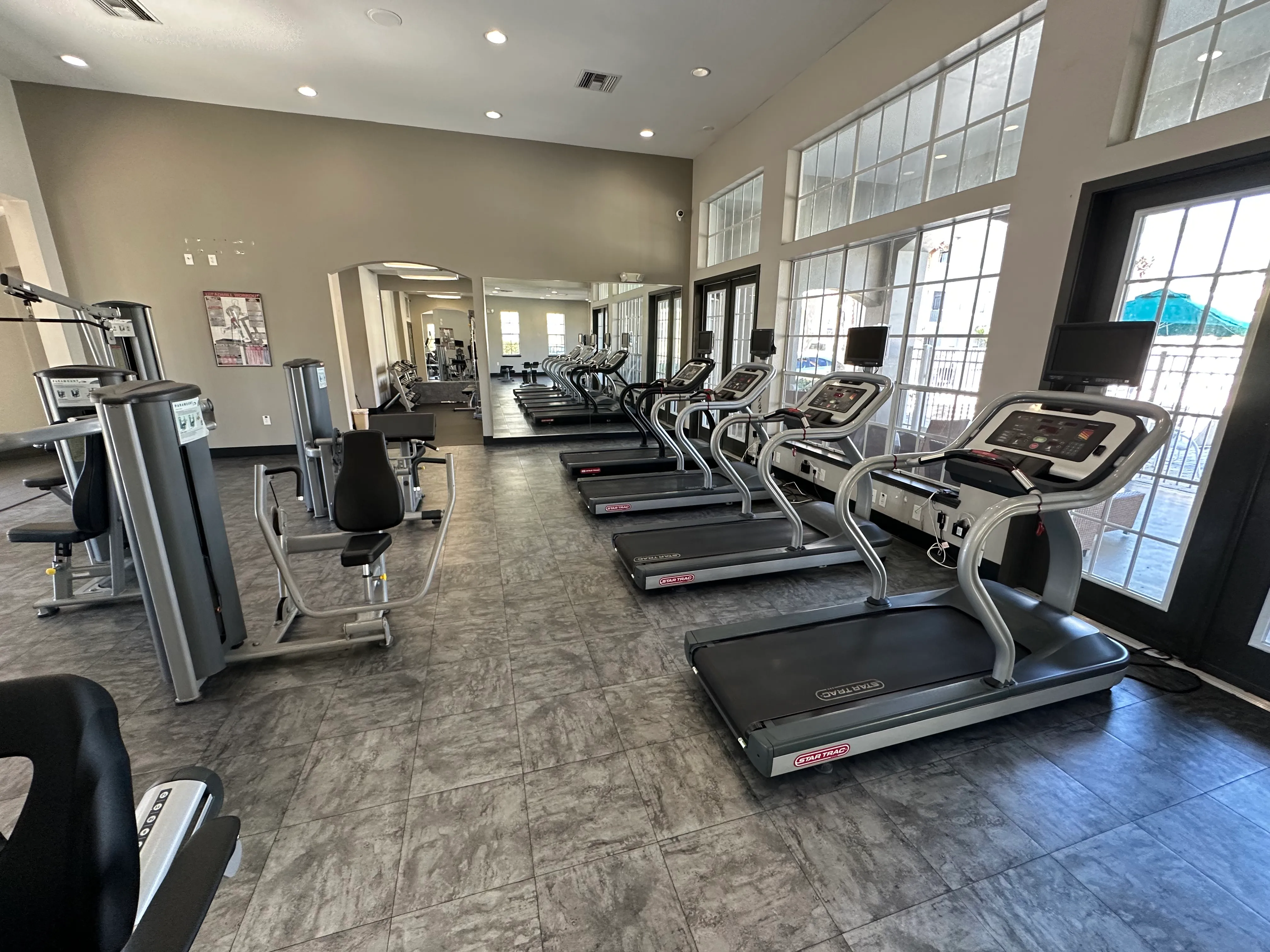 A gym with treadmills and elliptical machines.